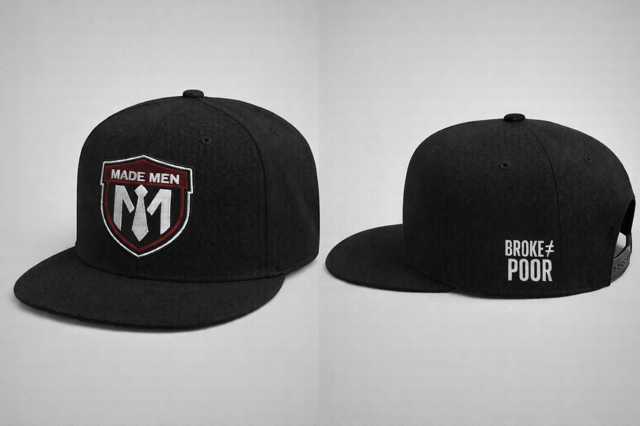 Black flat-brim snapback with embroidered shield and 'BROKE ≠ POOR' side hit.