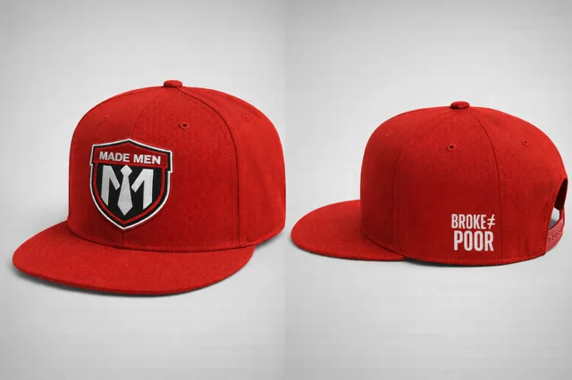 Red flat-brim snapback with embroidered shield and 'BROKE ≠ POOR' side hit.