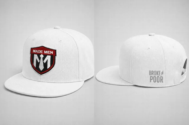 White flat-brim snapback with embroidered shield and 'BROKE ≠ POOR' side hit.