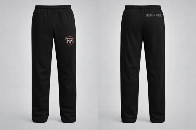 Open-hem black sweatpants with shield logo on thigh.